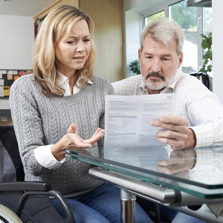 frustrated couple looking at paperwork